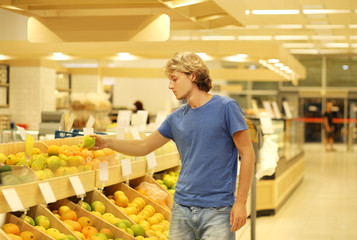 Teenager buying fruits at the market