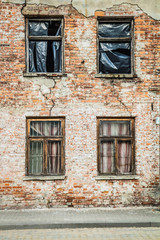Fototapeta na wymiar Abandoned brick building with broken windows