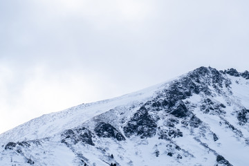 Fototapeta na wymiar View to mountain summit Großer Hengst on a cloudy winterday
