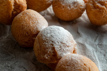 Cottage cheese balls on wooden skewers, lie on craft paper.