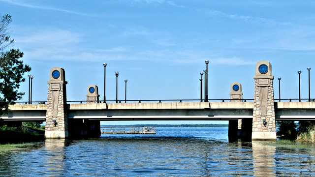 Boating in Minnesota - heading north on the Mississippi River and approaching Lake Bemidji under bridge with blue sky and water.