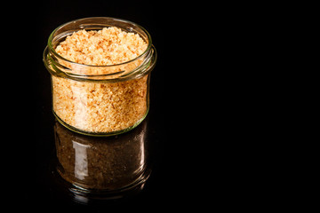 top view small glass jar with yellow organic sea salt