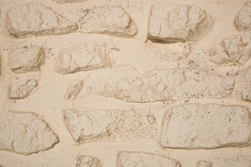 Closeup off-white painted stone wall background texture