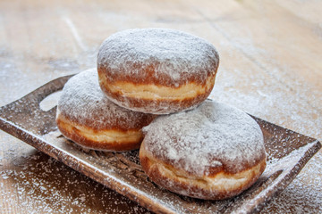 Donuts on a wooden tray