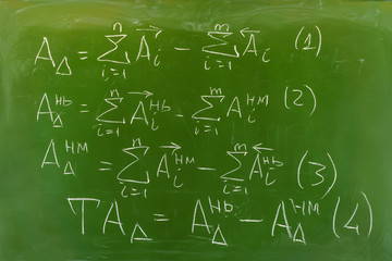 background - green chalkboard with hand-written formulas