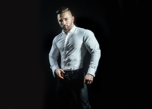 Portrait of successful attractive man in work uniform on black background. Stylish clothes for men at work, office style. Groom before his wedding ceremony. Men's style and fashion.