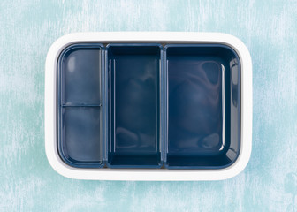 Empty lunch box on wooden table, top view