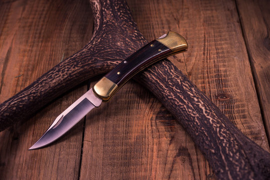 Premium knife. Legendary hunting knife. Hunting knife and antler.