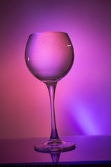 Glass of water on a colored background