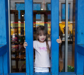 Obraz premium Cute little girl sticking her tongue out