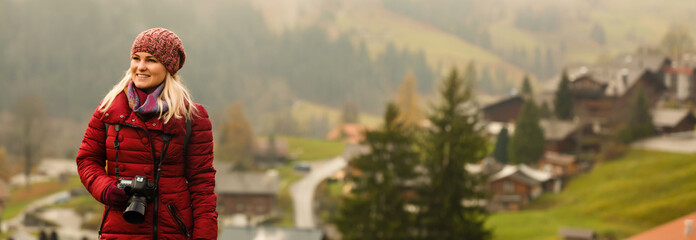 Beautiful girl photographer taking photos in the Swiss mountains. Switzerland.