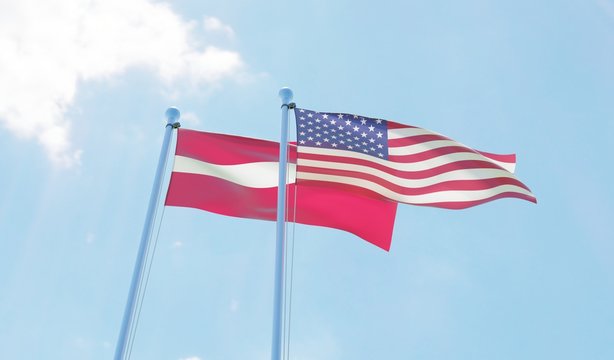 Latvia and USA, two flags waving against blue sky. 3d image