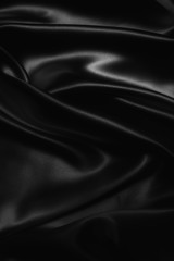 black abstract background luxury cloth or liquid wave or wavy folds of grunge silk texture satin velvet material or luxurious Christmas background or elegant wallpaper design, background