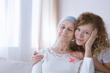 Beautiful daughter supporting mother with breast cancer
