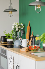 Bread and vegetable salad on wooden counter of trendy kitchen