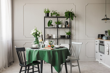 Breakfast on table in stylish grey kitchen in elegant apartment
