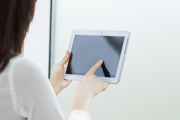 close up.businesswoman clicking on the screen of the digital tablet