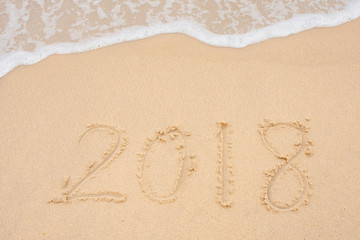 Soft wave and Number 2018 of sea on empty sandy beach Background with copy space