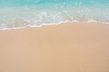 Obraz na płótnie Canvas Soft wave of sea on empty sandy beach Background with copy space