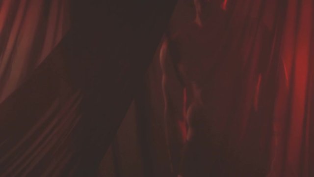 Man is dancing behind a thin cloth