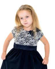 Little girl posing in studio on a white background.