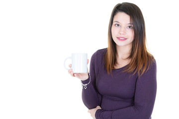 Caucasian young woman drinking coffee or tea smiling at camera with blank white copy space