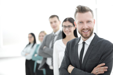 confident businessman standing in front of his business team