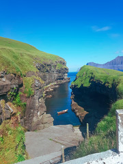 View of a boat between two cliffs