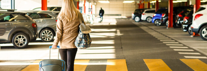 Girl with bag in the parking at the airport - obrazy, fototapety, plakaty