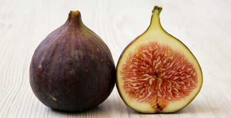 Fresh figs on white wooden background, side view. Close-up.