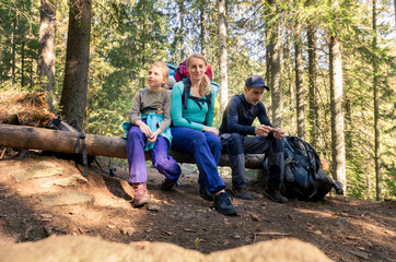 Family in the forest. The family of tourists in the forest. Family in a hike.