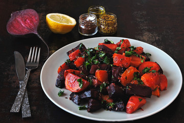 Salad of baked beets, pumpkins and carrots. Warm salad of winter vegetables. Healthy vegan salad with baked vegetables. Beet salad with pumpkin and carrot.