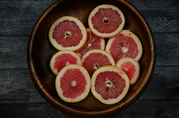 Grapefruit slices background. Top view, summer vibes color