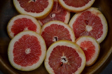 Grapefruit slices background. Top view, summer vibes color