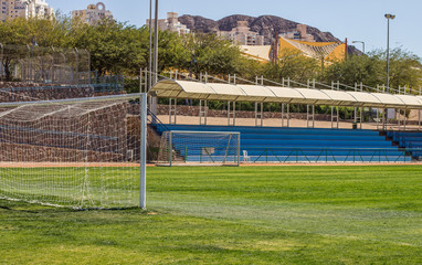 football field and gates front side with empty tribunes background