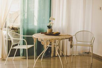 vintage interior room with pastel white and soft rose colors with furniture chairs and table minimalism design