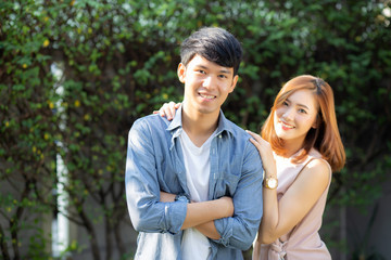 Beautiful portrait couple looking each others eyes and smiling with happy, young asian man and woman relation with love dating, husband and wife feeling and emotion, lovers and lifestyle concept.