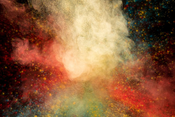 Fototapeta premium Colored powder explosion on black background. Freeze motion.