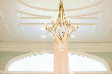 White wedding dress Hanging from chandelier