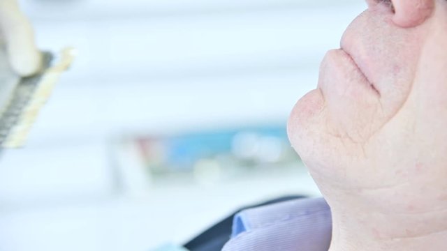 Close-up stomatologist selects a color for the patient to create a prosthesis. Dentistry in 4k