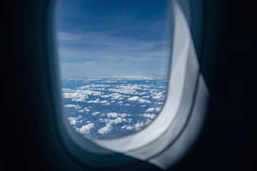 View from airplane window. Aerial landscape. Flying over clouds