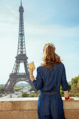 Fototapeta na wymiar trendy tourist woman with coffee cup in Paris, France