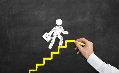 Concept of promotion and success in business life. man drawing yellow stairs