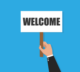 Businessman holding welcome banner