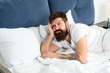 Man bearded hipster woke up too early and feels sleepy and tired. Early to get up. Keep you wide awake in the early morning hours. Insomnia and sleep problems. Reasons you are waking up too early