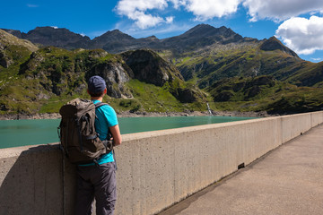 Young hiker is enjoying the scenery at Lago di Robiei in Ticino, Switzerland