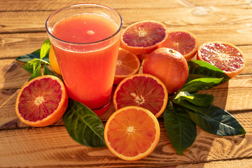 Glass With Orange Juice Of Blood Oranges With Fresh Fruits. Outdoor Shot In The Sunshine
