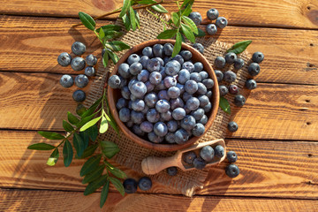 Fototapeta na wymiar Blueberries On Old Wooden Planks Top View. Outdoor Image Shot In The Sunshine