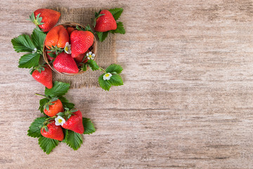 Strawberry basket on vintage background. Top view, text space