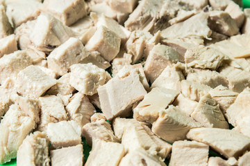 Diced boiled chicken meat on a green board